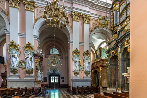 Widok na filary nawowe z figuralnymi rzeźbami i fragmentem prospektu organowego.