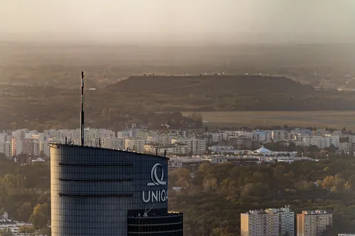 Górny fragment biurowca Intraco II (UNIQA) widoczny na tle zachodniej części Warszawy z Varso.