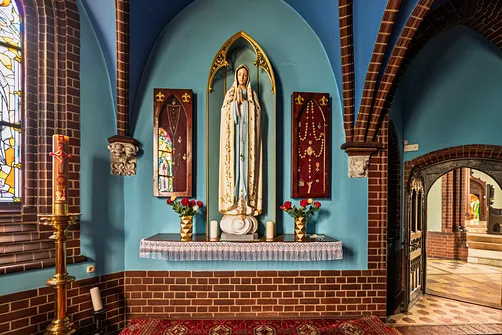 Statua Matki Bożej Fatimskiej w ostrołukowej wnęce kaplicy rybnickiego kościoła.