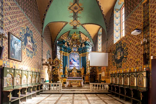 Prezbiterium żywieckiej świątyni z historycznymi stallami i ołtarzem.